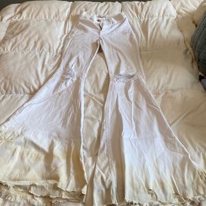 high waisted stretchy jeans, bell bottoms, slightly discolored at the bottom,